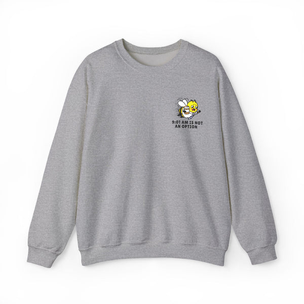 Heather ash grey crewneck sweatshirt featuring a small graphic on the left chest of a rushing cartoon bee holding a coffee cup, with black text below reading "9:01 AM IS NOT AN OPTION" on a solid white background.