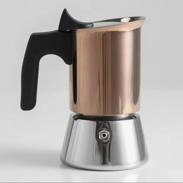 Rose gold and stainless steel moka pot stovetop espresso maker with a heat-resistant black handle on a white background.