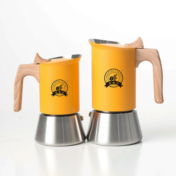 Two yellow coffee makers with wooden handles on a white background