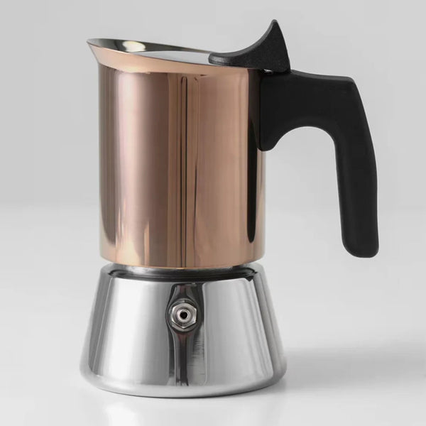 Rose gold and stainless steel moka pot stovetop espresso maker with a heat-resistant black handle on a white background.