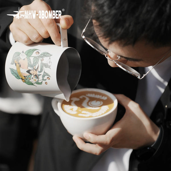 Professional barista using MHW-3BOMBER Origin Series milk pitcher to pour precision latte art into a white coffee cup.