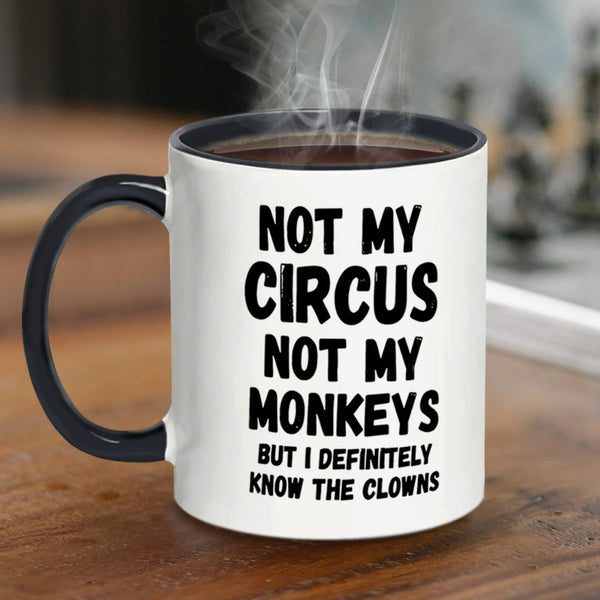 Mug with text 'Not my circus, not my monkeys, but I definitely know the clowns' on a wooden surface.