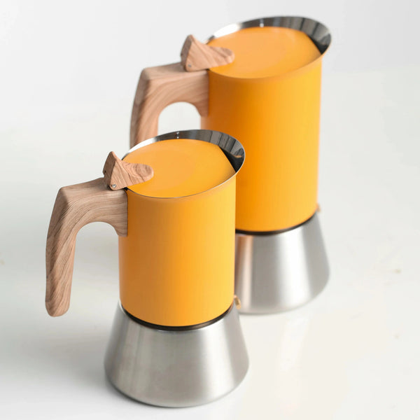 Two orange coffee moka pots with wooden handles on a white background