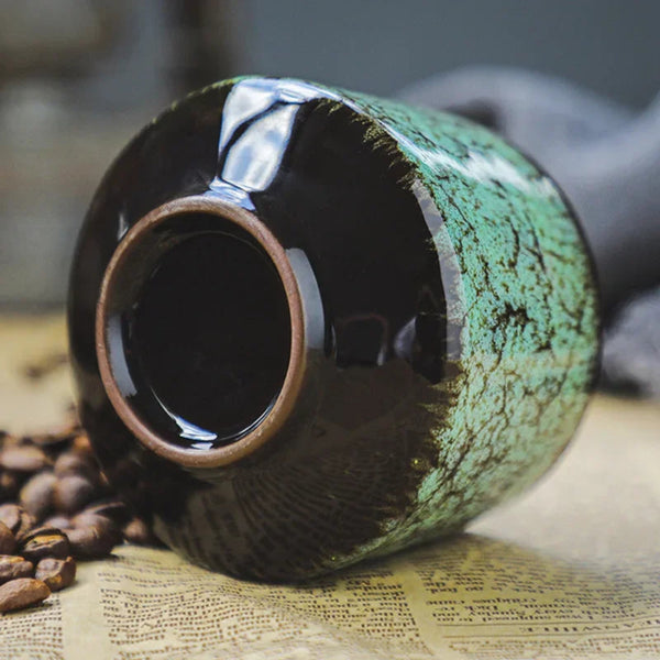 Bottom detail of a reactive glaze ceramic espresso mug showing durable craftsmanship, stable base, and cracked moss texture.