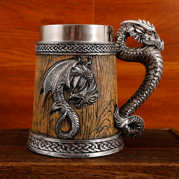 Front-facing view of the antique silver medieval dragon barrel tankard variant featuring a light golden-oak wood grain resin body and a detailed silver dragon emblem with a sculpted tail handle.