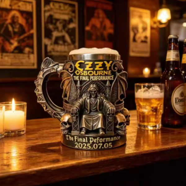Ozzy Osbourne commemorative gothic beer mug featuring a 3D skeleton king on a throne with bats, skulls, and a stainless steel rim on a bar counter.