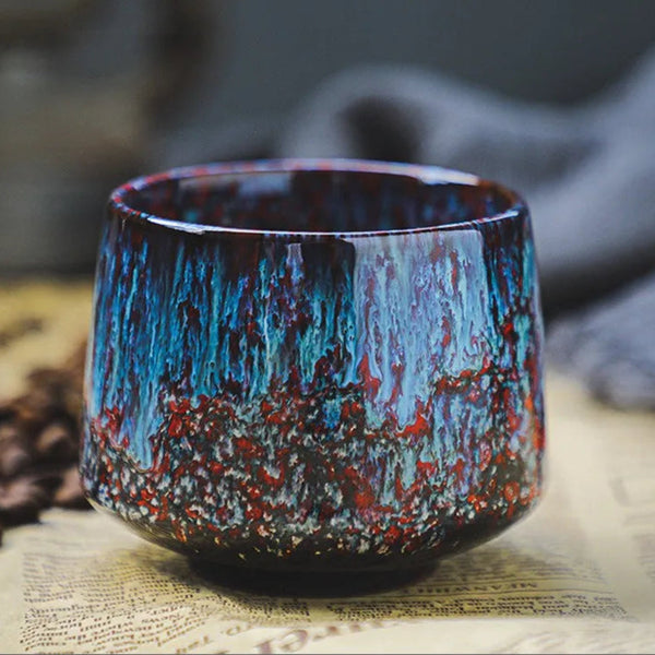 Plum Red minimalist ceramic cup featuring a cosmic deep ocean blue and crimson speckled finish.