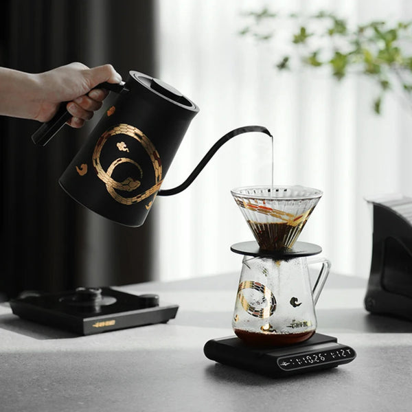MHW-3BOMBER Serpent Series manual brew kit including the Assassin Gooseneck Kettle and 500ml Glass Server on a digital coffee scale.