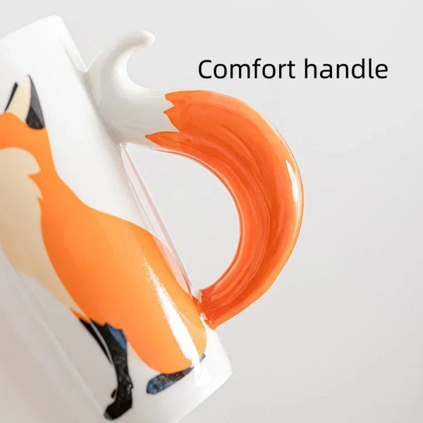 Close-up view of a ceramic fox coffee mug highlighting a smooth, sculpted orange and white 3D fox tail comfort handle.