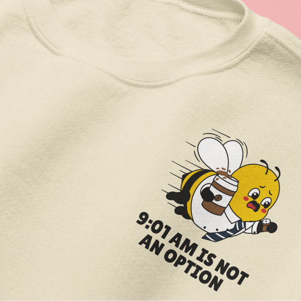 A premium corporate bee with the slogan "9:01 AM IS NOT AN OPTION" on the left chest of an oatmeal cream crewneck sweatshirt.